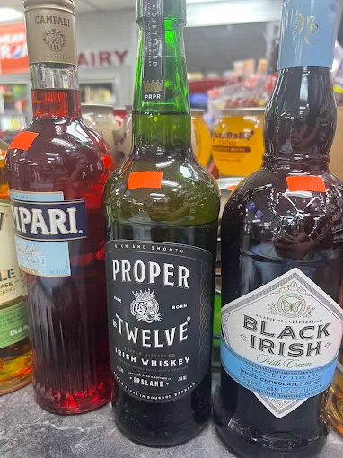Assorted premium spirits including Proper Twelve and Campari