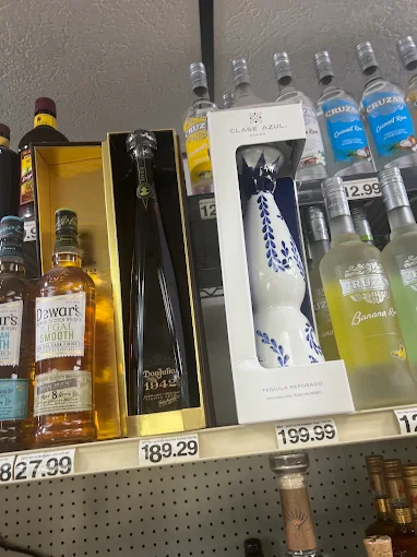 High‑end liquor bottles on upper shelves with price tags
