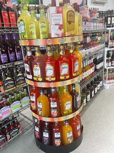 Display of colorful bottled beverages on rotating stand